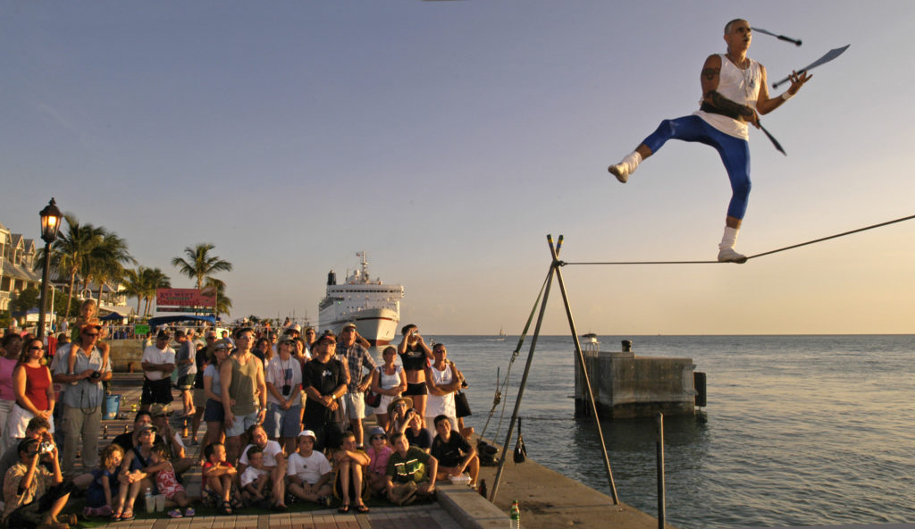 A street performer juggles on a tightrope at the sunset celebration in Key West