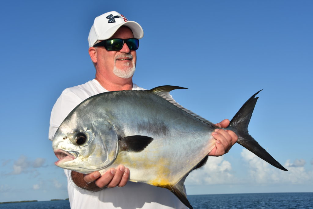 an angler holds a nice permit he caught while sight fishing near key west