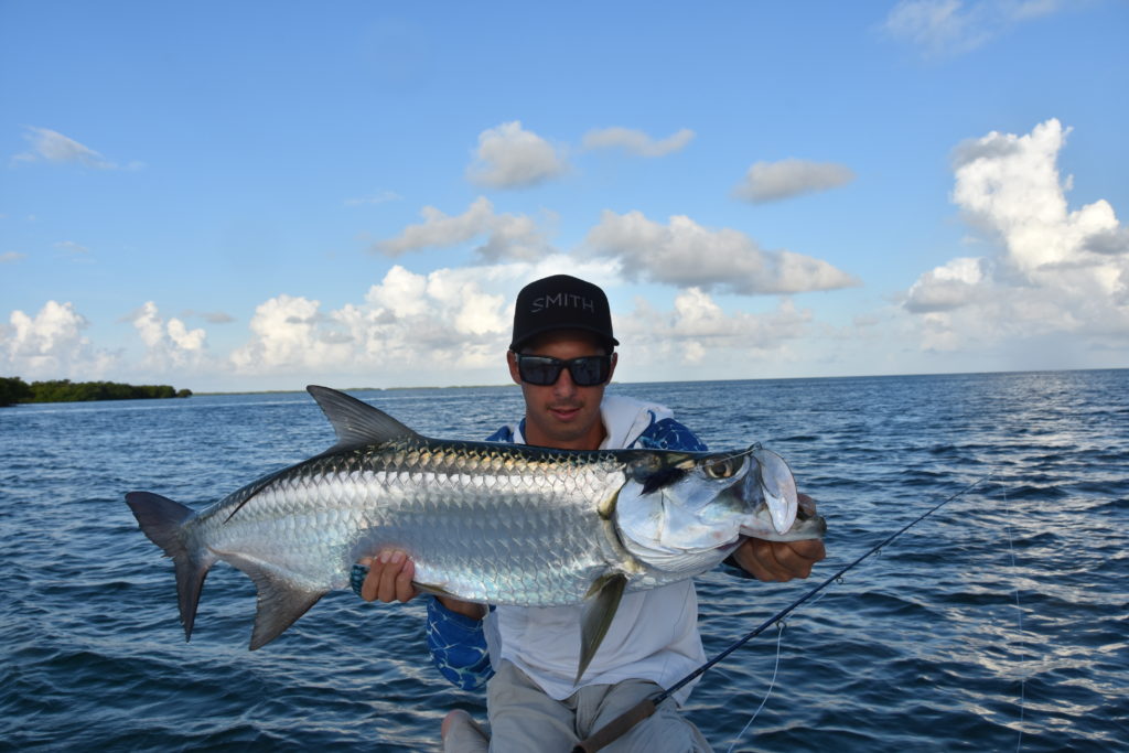 angler Saint Taha holds a nice tarpon he caught with a fly rod in the backcountry off of key west