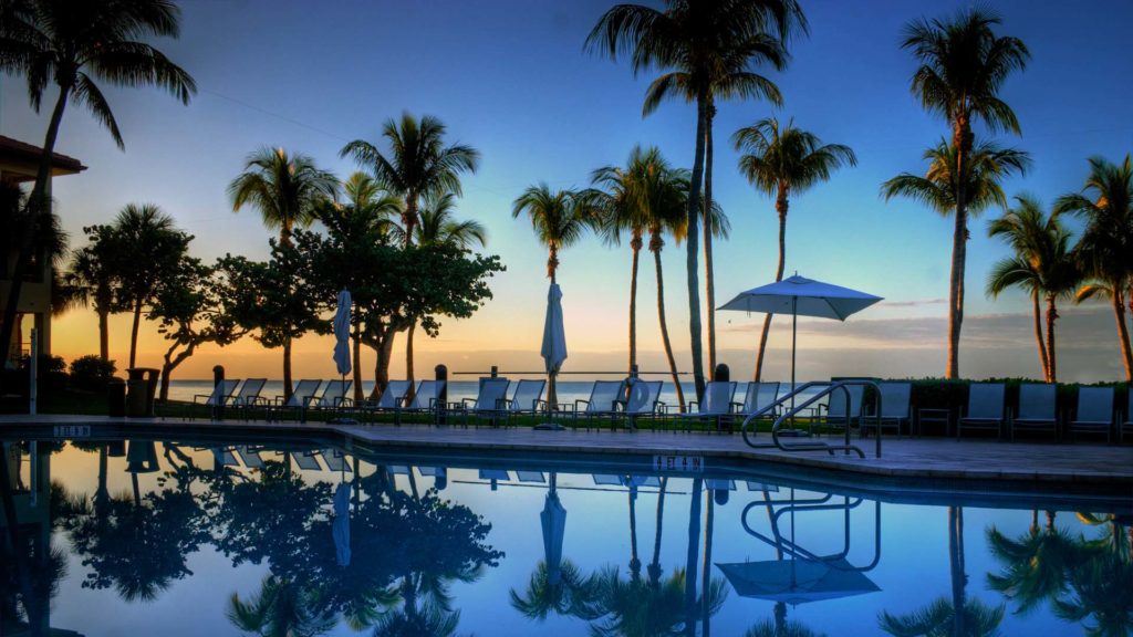 the sun goes down over the pool at the casa marina resort in key west Florida