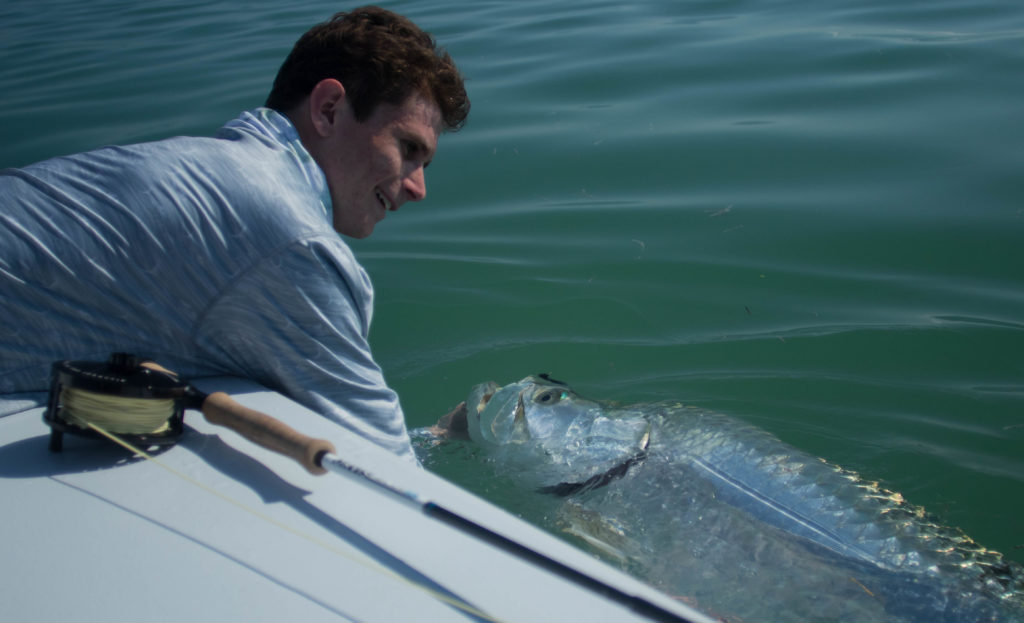Angler Bryce holds a nice tarpon caught on fly in Key West