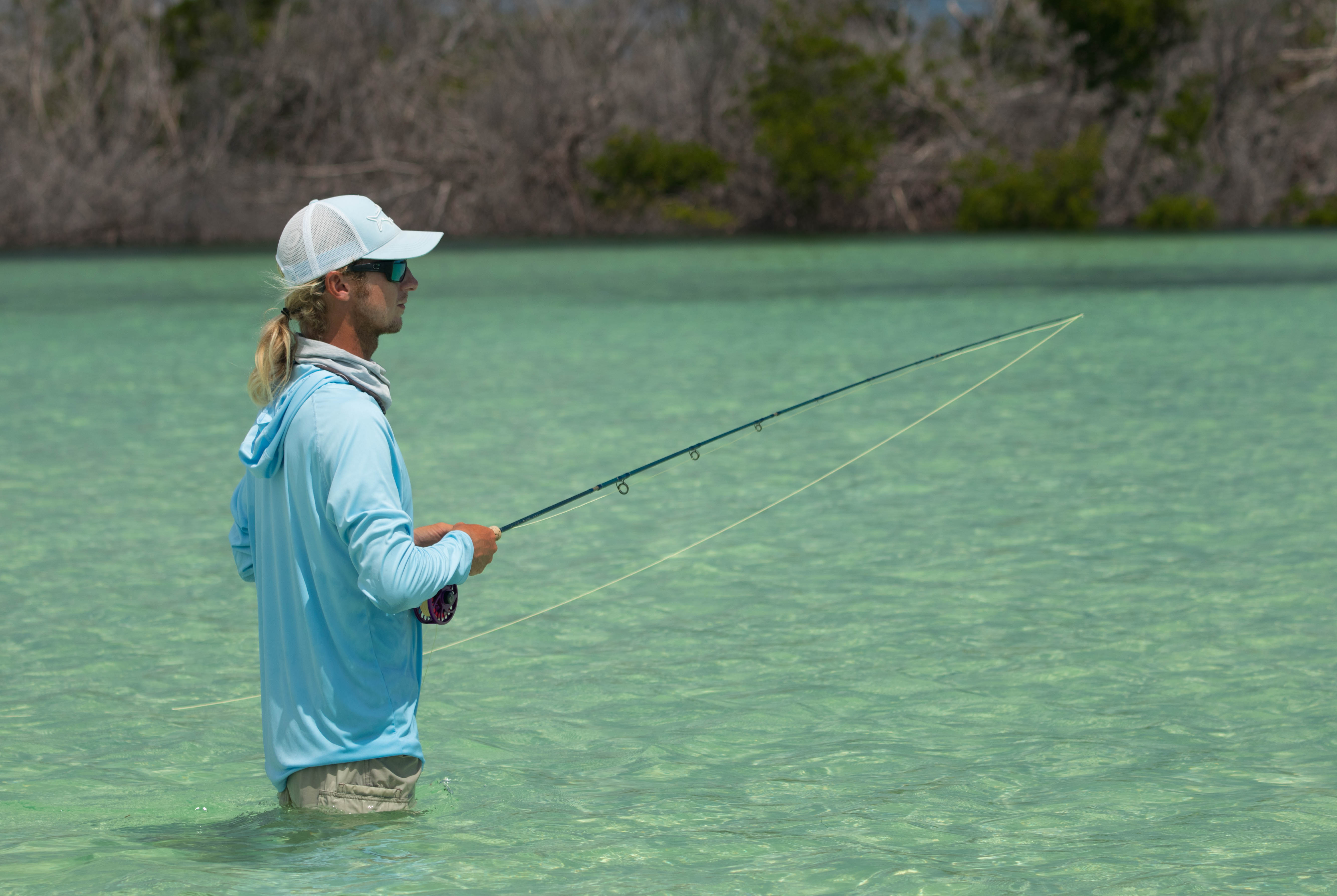 Angler Bryson is trying to fly fish for bonefish over a beautiful sand flat in the Florida Keys